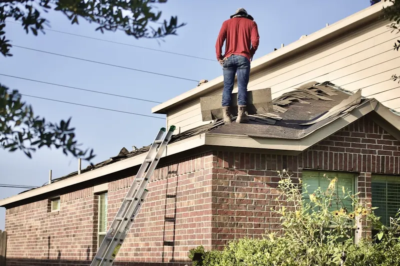 Professional roofer working on a residential roof in Park of the Canals